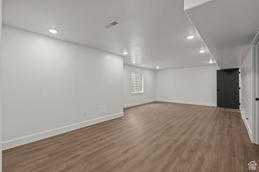 Empty room with wood finished floors and recessed lighting