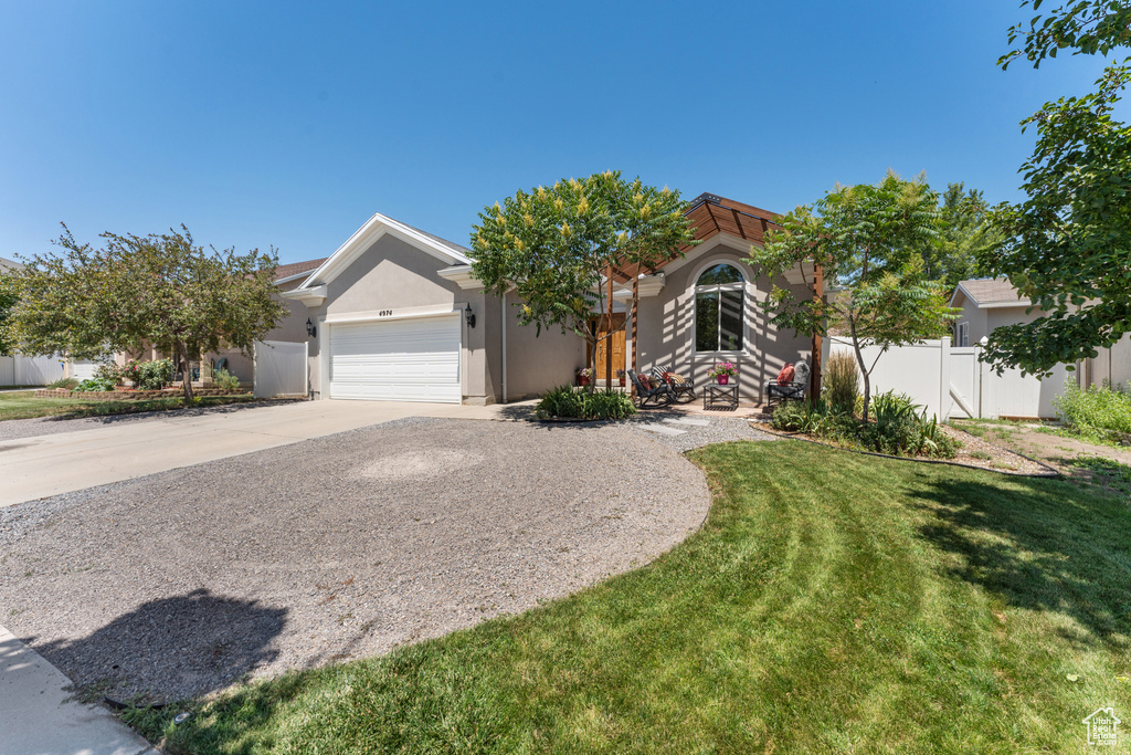View of front of property with stucco siding, concrete driveway, and a garage