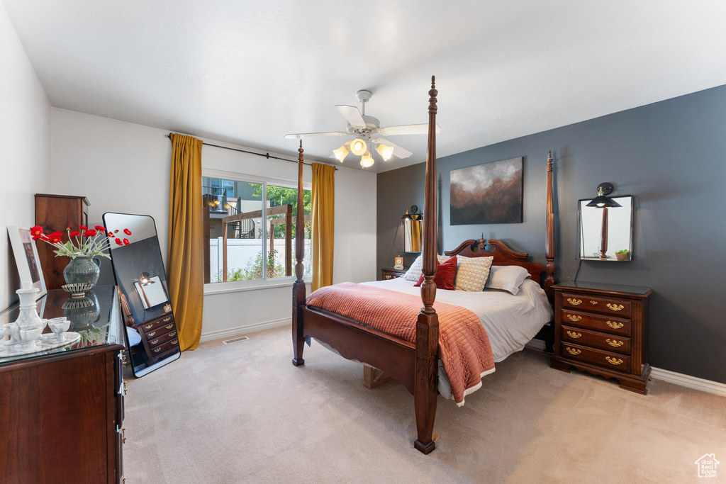 Bedroom featuring light carpet and a ceiling fan