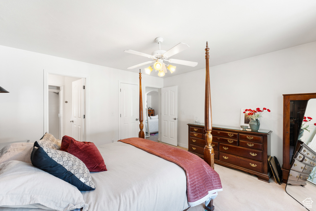 Bedroom with light carpet and a ceiling fan