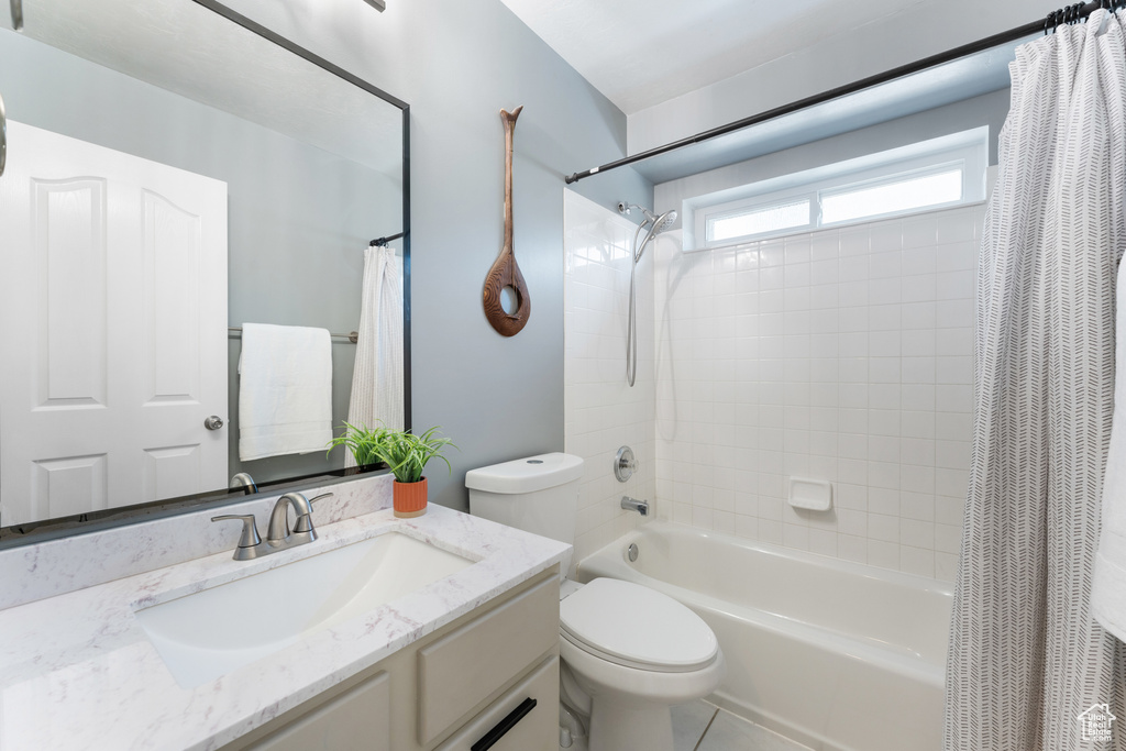 Full bathroom with shower / bath combo with shower curtain and vanity
