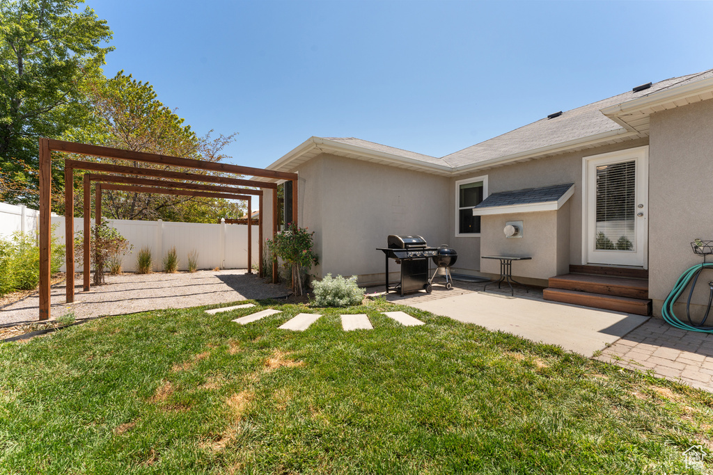 View of yard featuring a patio, a pergola, and entry steps