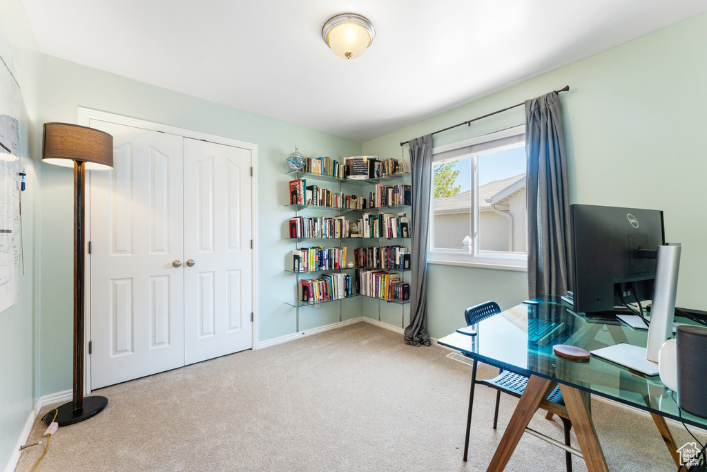 Carpeted office space featuring baseboards