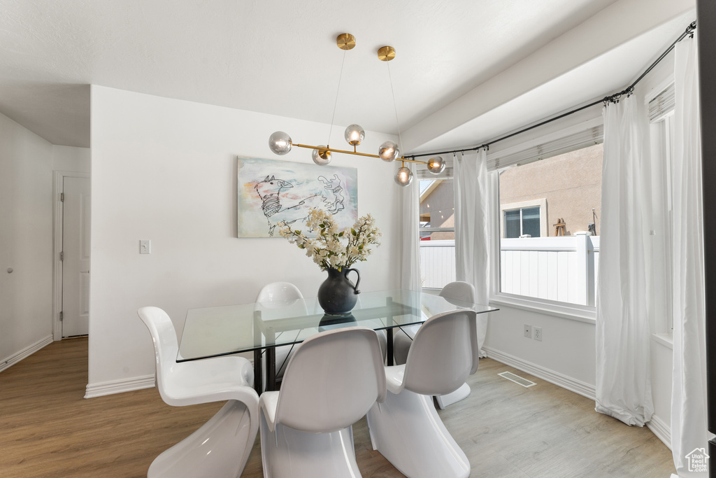 Dining area with light wood-style floors and baseboards