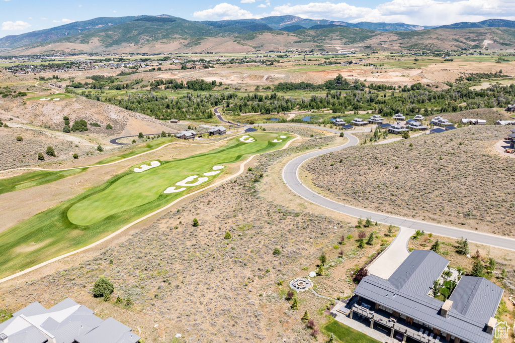 Drone / aerial view of a mountain backdrop and a golf course