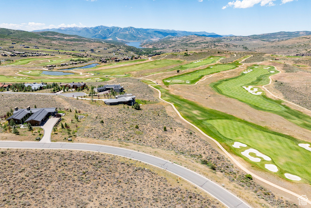 Drone / aerial view of a water and mountain view and a golf club