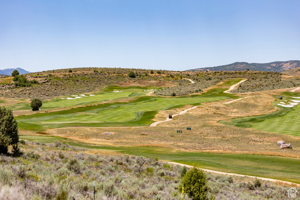 View of community with a mountain view and view of golf course