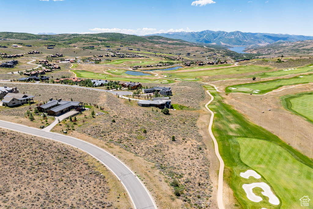 Aerial perspective of suburban area featuring a water and mountain view and a local golf course