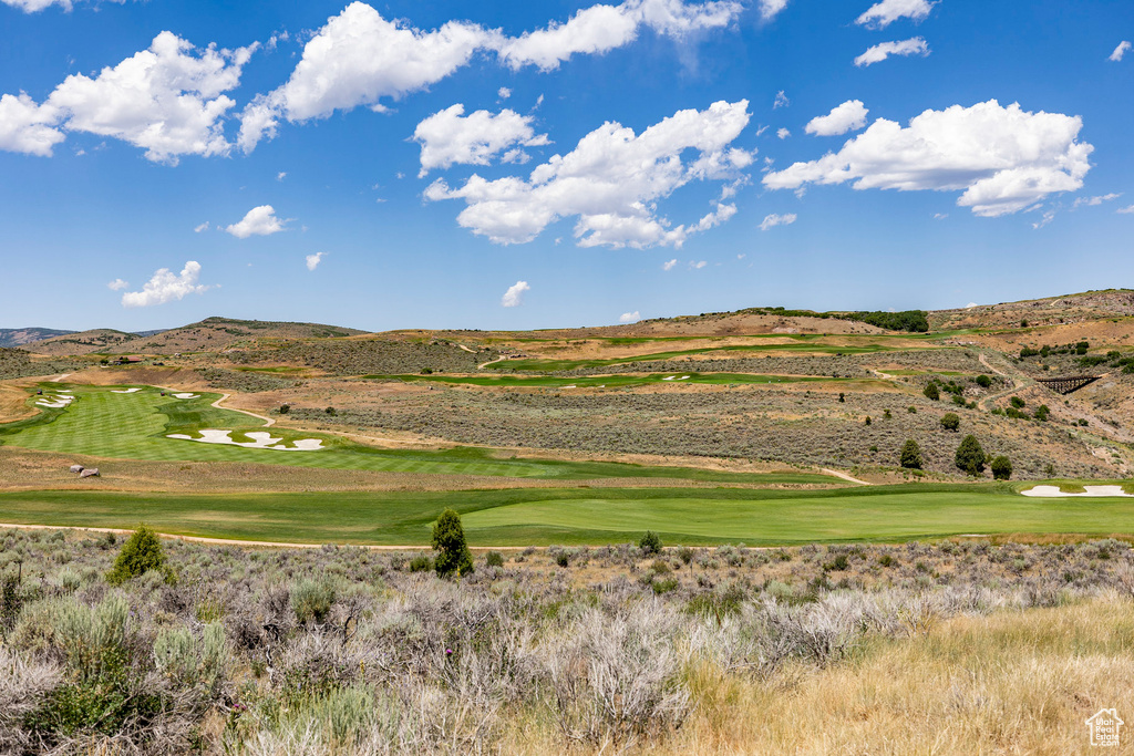 View of property's community with a mountain view and view of golf course