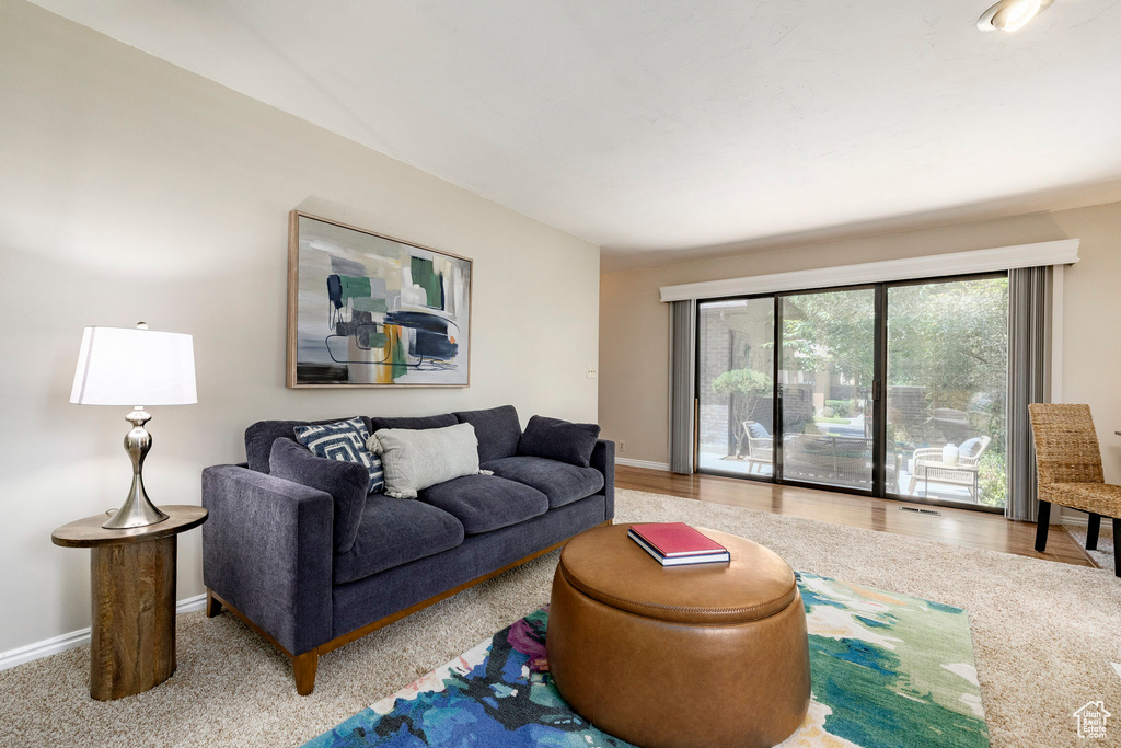 Living area featuring baseboards and carpet flooring