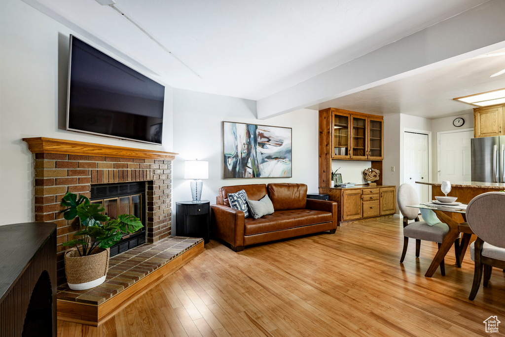 Living area featuring light wood-style floors and a fireplace
