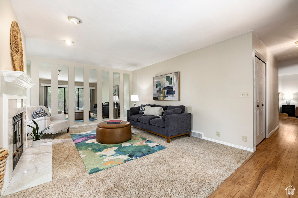 Living room featuring hardwood / wood-style flooring, french doors, and a premium fireplace