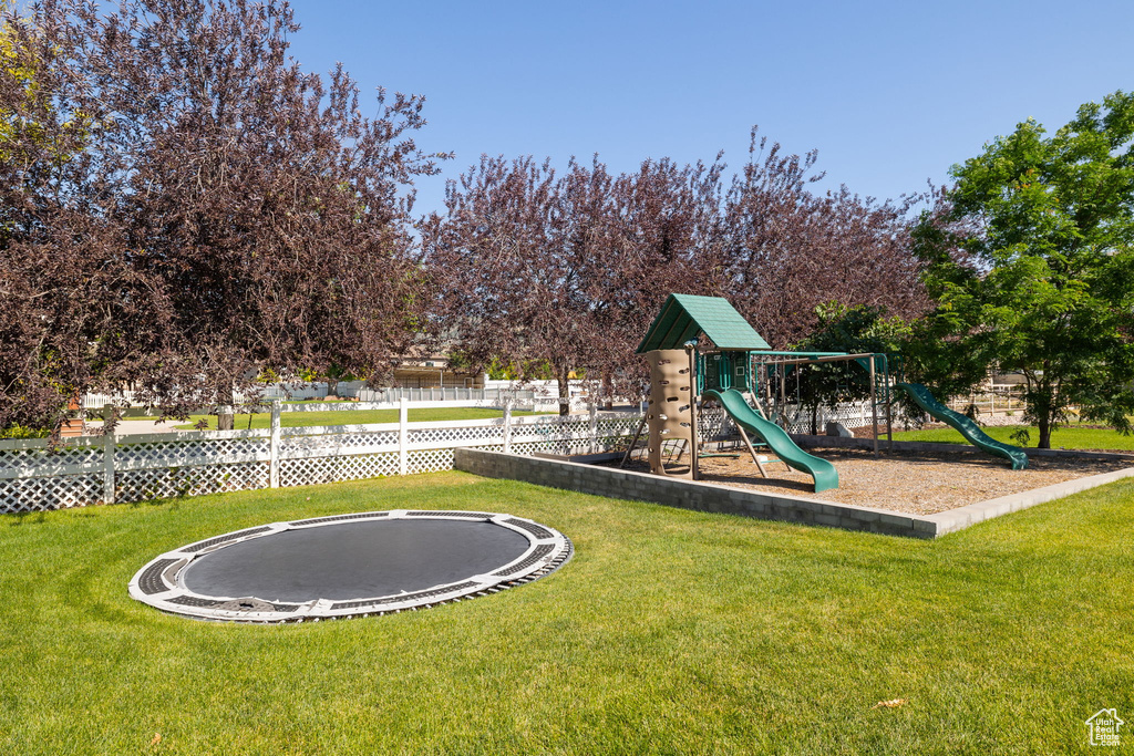 Community playground featuring a trampoline