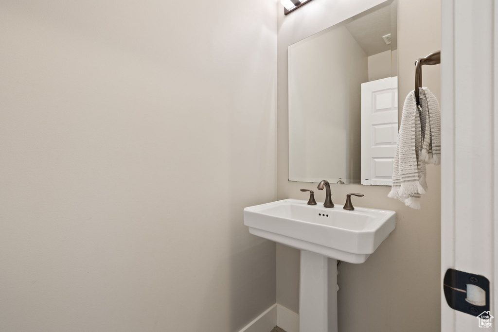 Bathroom with baseboards and a sink