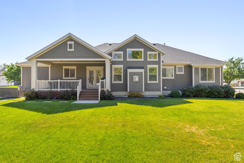 View of front facade with a front lawn and covered porch