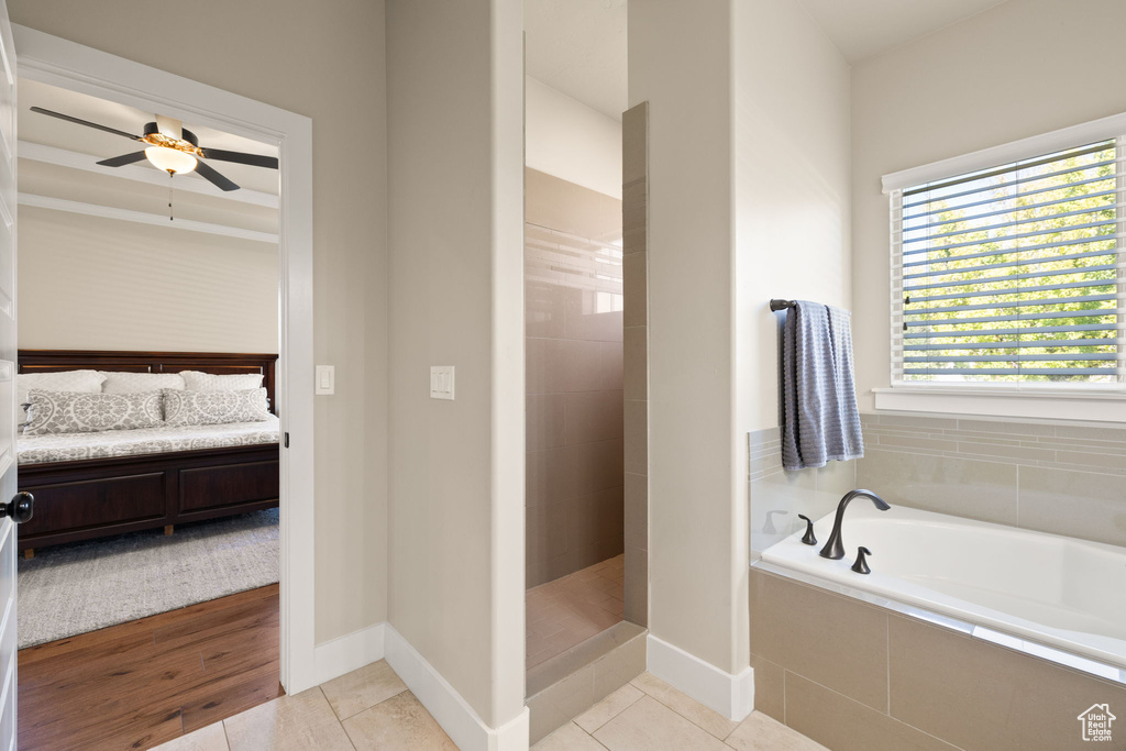 Ensuite bathroom with a bath, walk in shower, a ceiling fan, and tile patterned flooring