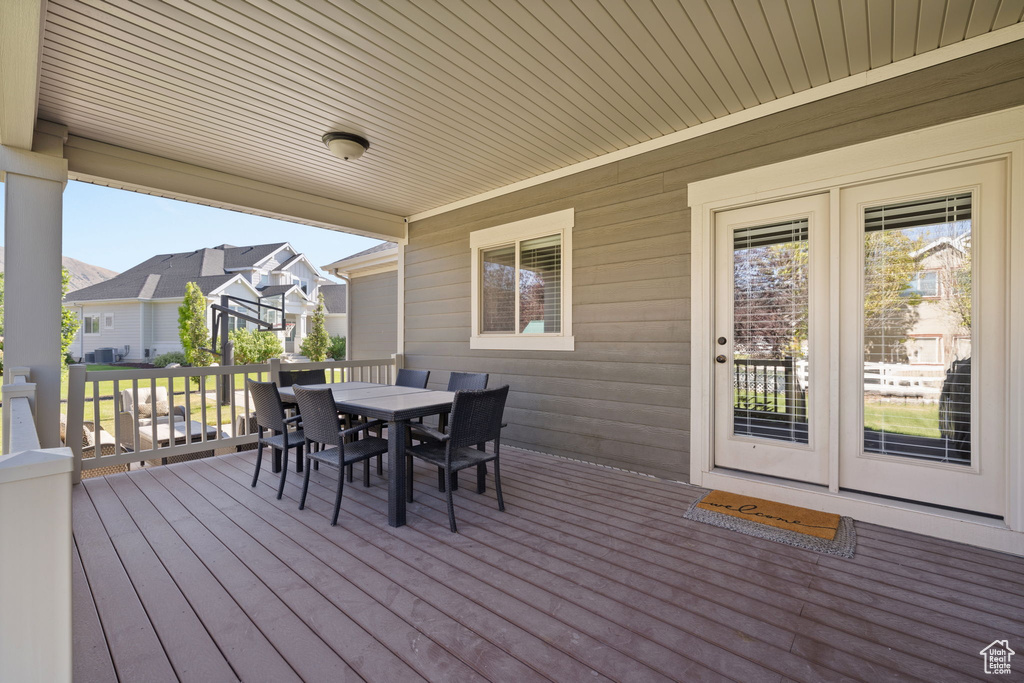 Deck with outdoor dining area and a residential view
