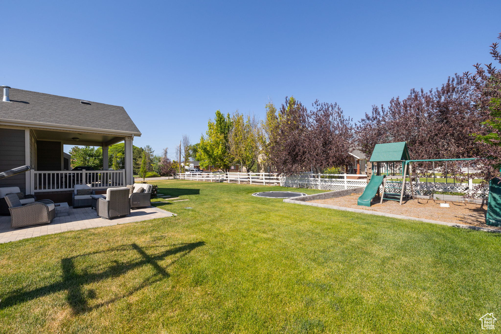 View of yard with outdoor lounge area and a patio