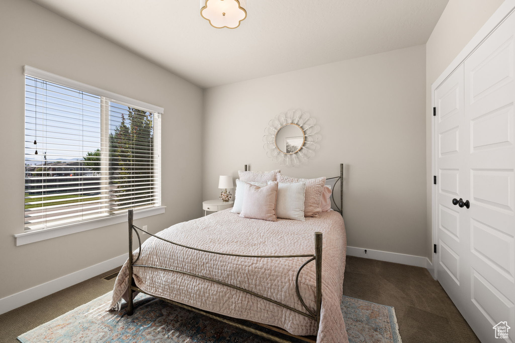 Carpeted bedroom with baseboards