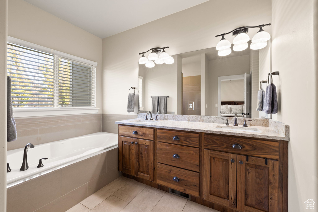 Bathroom with double vanity and a bath