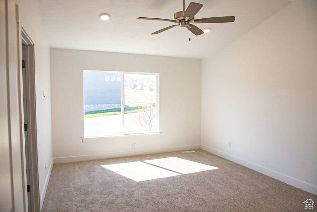 Carpeted empty room with a ceiling fan and recessed lighting