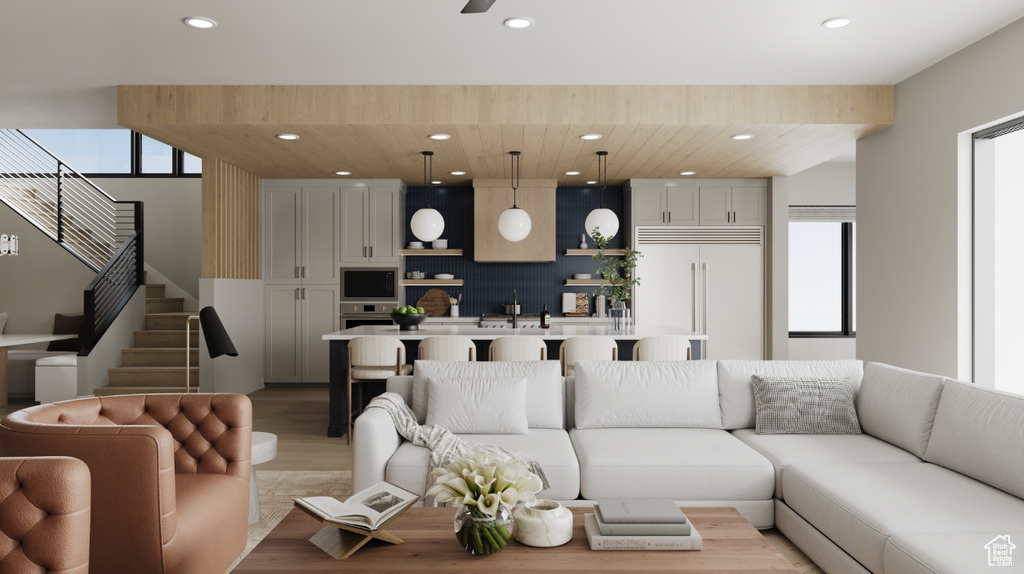 Living room with stairs, recessed lighting, and light wood-style floors