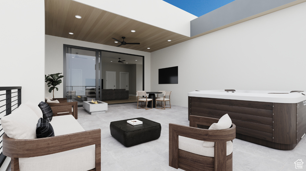 View of patio with a hot tub, an outdoor hangout area, and ceiling fan