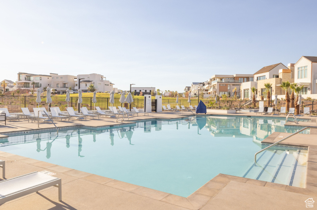 Community pool with a residential view and a patio area
