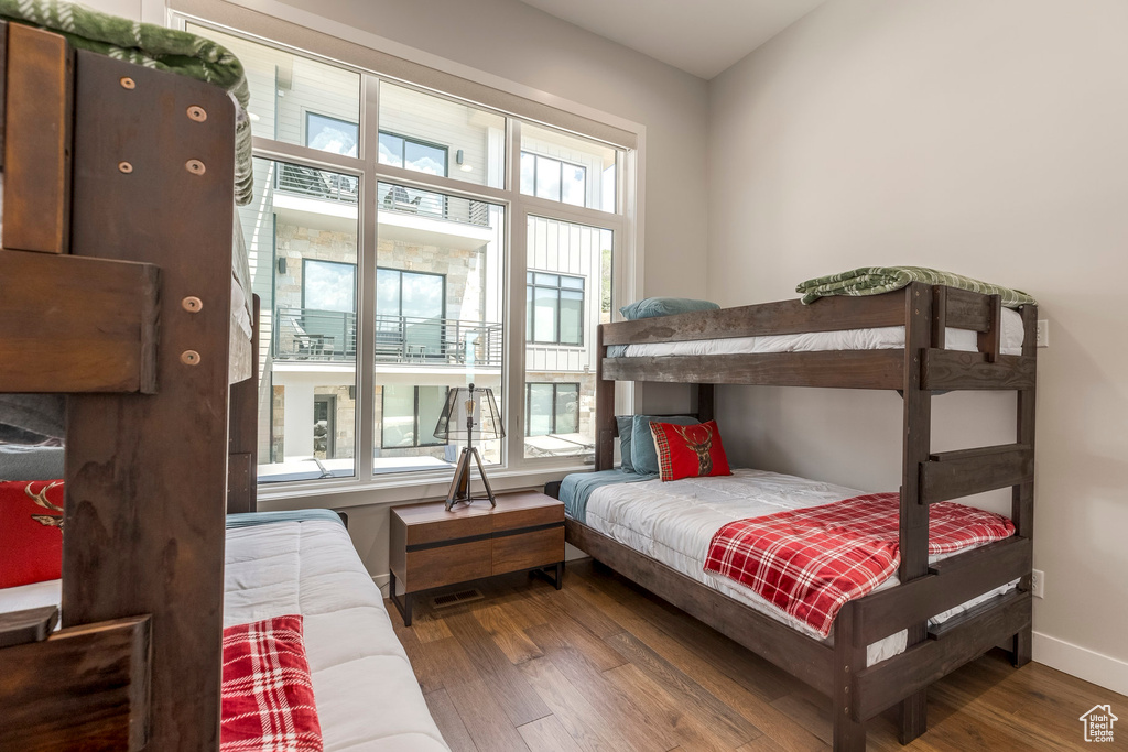 Bedroom with wood finished floors and baseboards