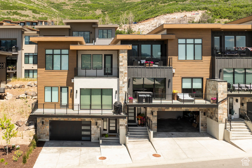 View of building exterior featuring a garage and concrete driveway