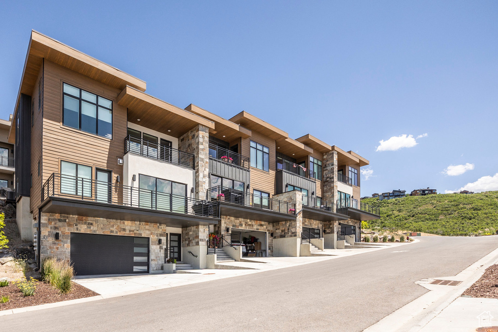 View of apartment building / complex featuring a garage