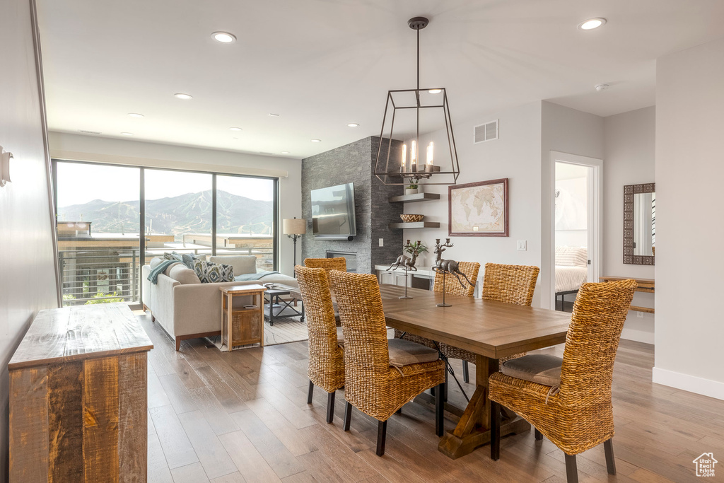 Dining room featuring wood finished floors, recessed lighting, and a chandelier