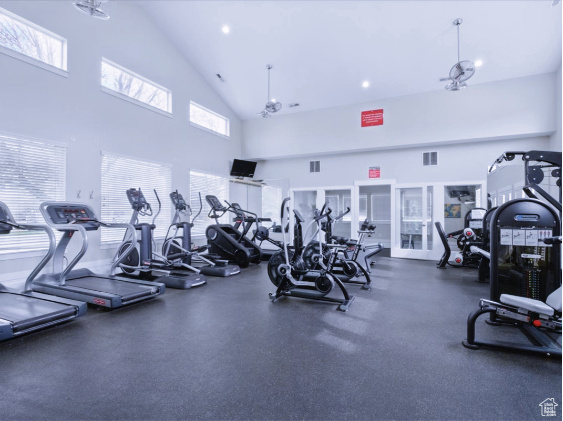 Gym featuring healthy amount of natural light, high vaulted ceiling, and recessed lighting