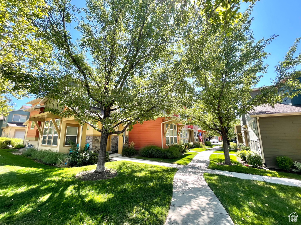 View of front of property featuring a front lawn and a residential view