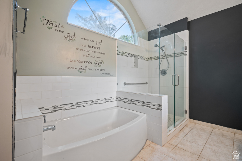 Full bath with a bath, a shower stall, tile patterned flooring, and lofted ceiling