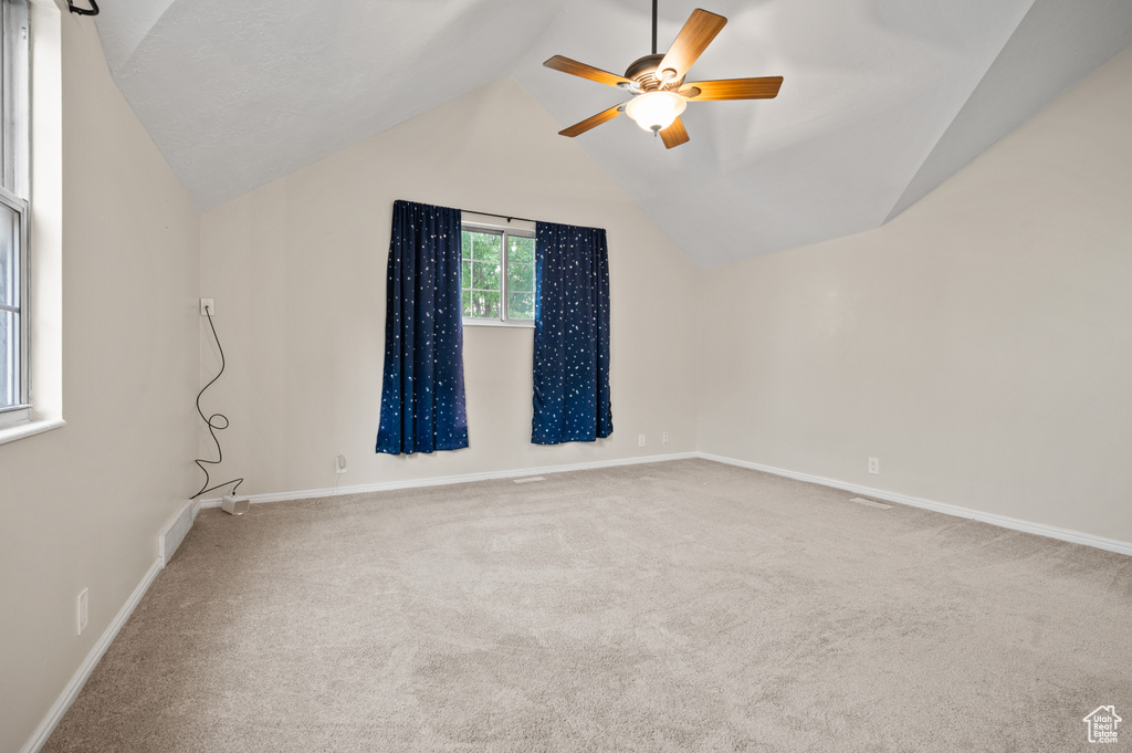 Bonus room featuring lofted ceiling, a ceiling fan, and carpet floors