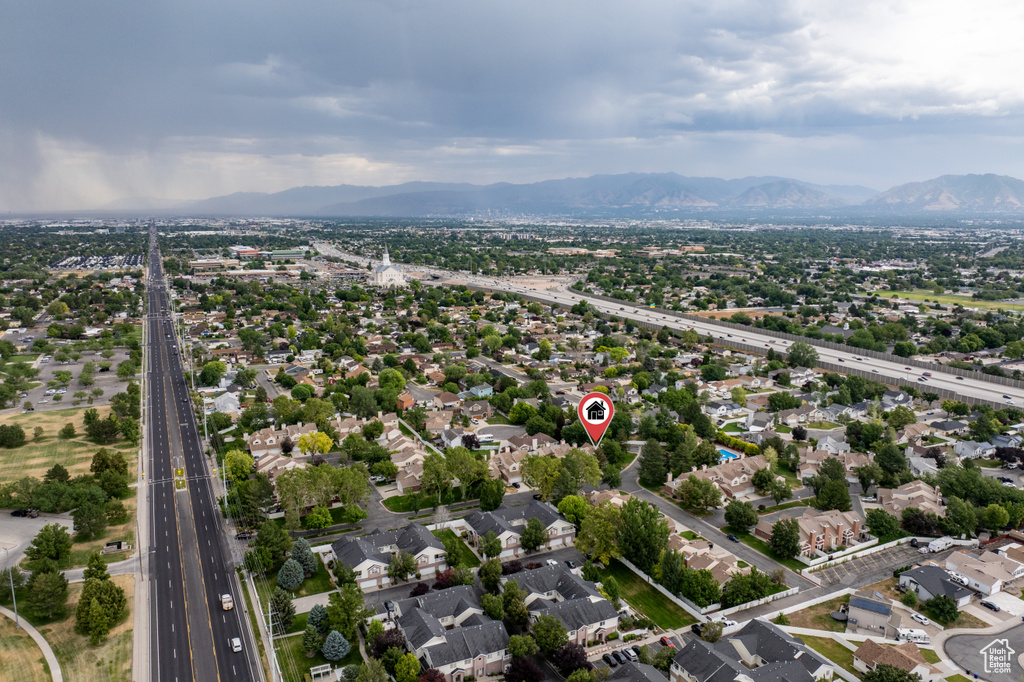 Aerial view of residential area featuring a main thoroughfare and mountains