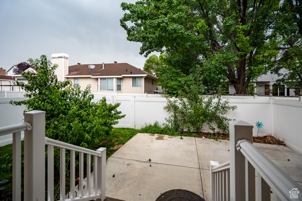 Fenced backyard with a patio