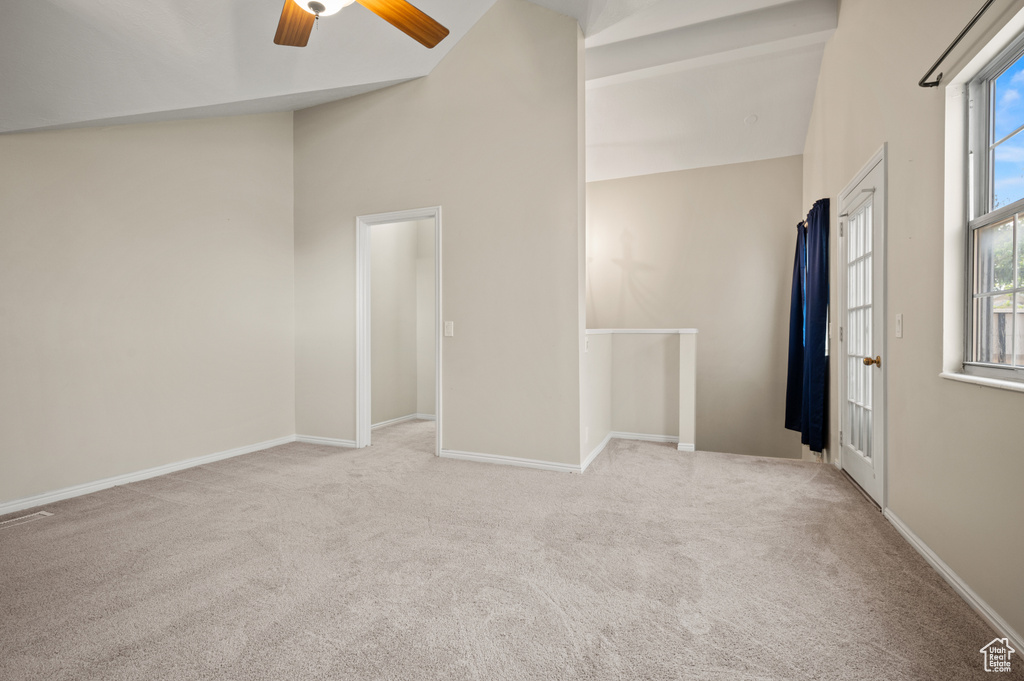 Unfurnished bedroom featuring carpet flooring, ceiling fan, and high vaulted ceiling
