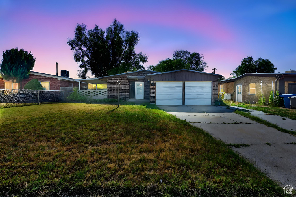 Ranch-style house featuring brick siding, concrete driveway, and an attached garage