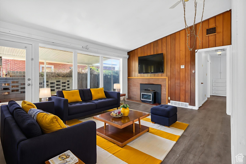 Living room with wooden walls and wood finished floors