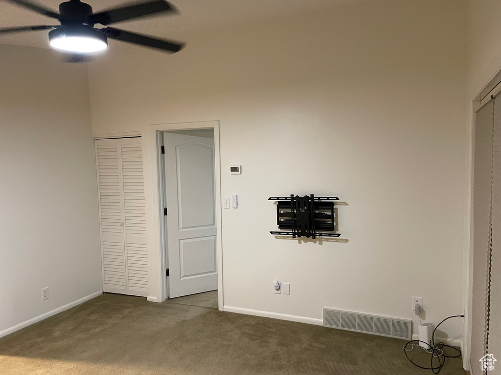 Unfurnished bedroom with carpet floors and a ceiling fan