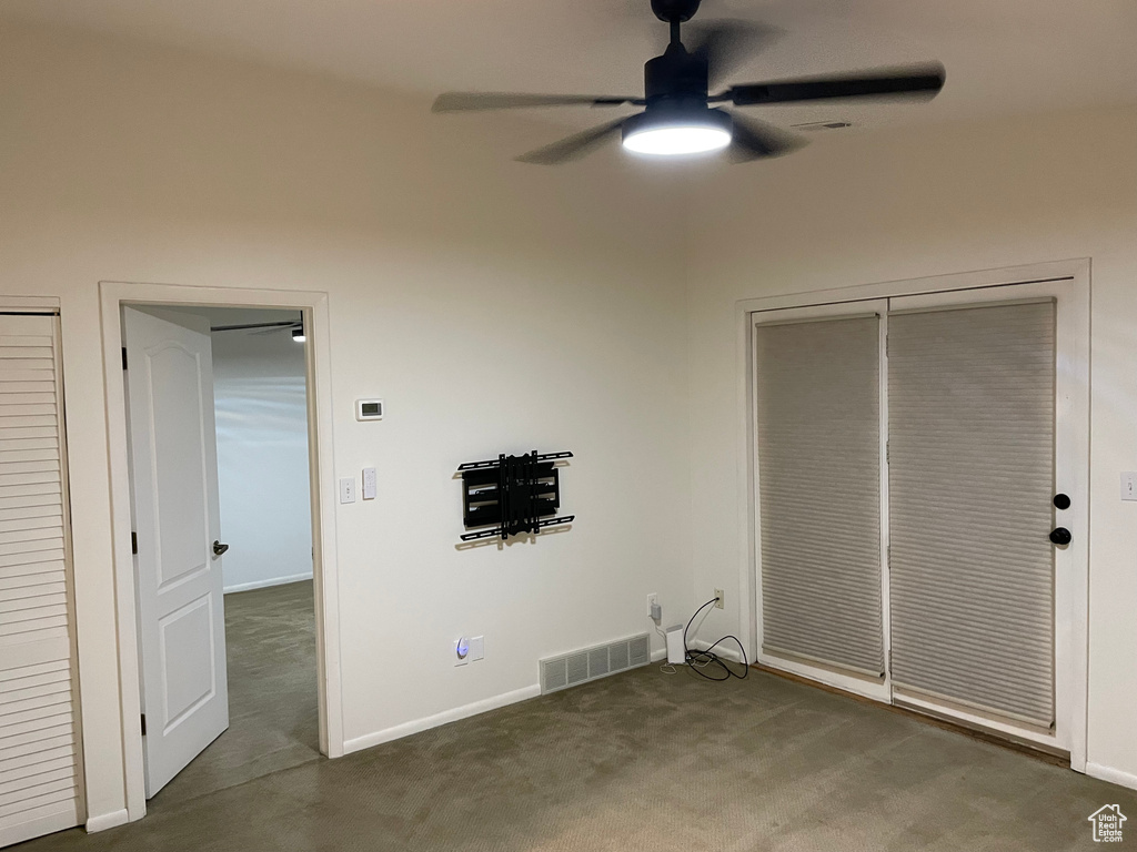 Unfurnished bedroom with carpet and a ceiling fan