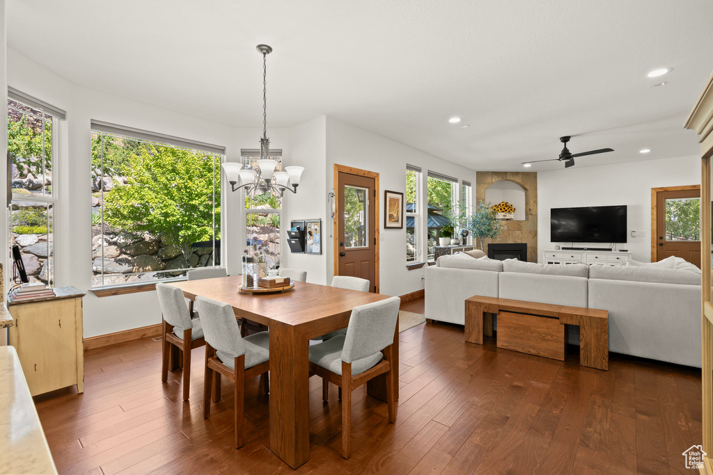Dining area featuring recessed lighting, a chandelier, dark wood-type flooring, and healthy amount of natural light