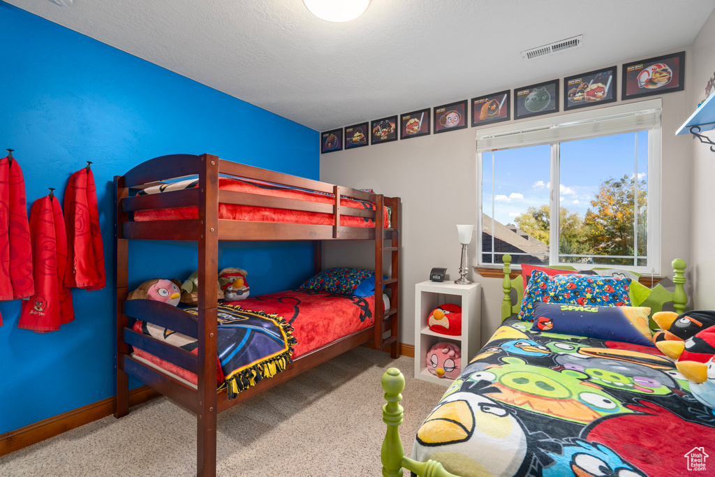 Bedroom with carpet floors and baseboards