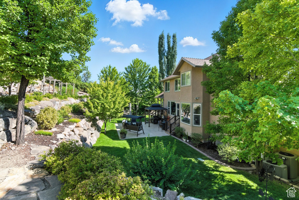 View of grassy yard with a gazebo, a patio, and outdoor lounge area