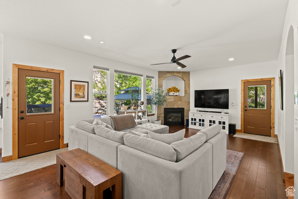Living area with a tile fireplace, ceiling fan, dark wood-style floors, and recessed lighting