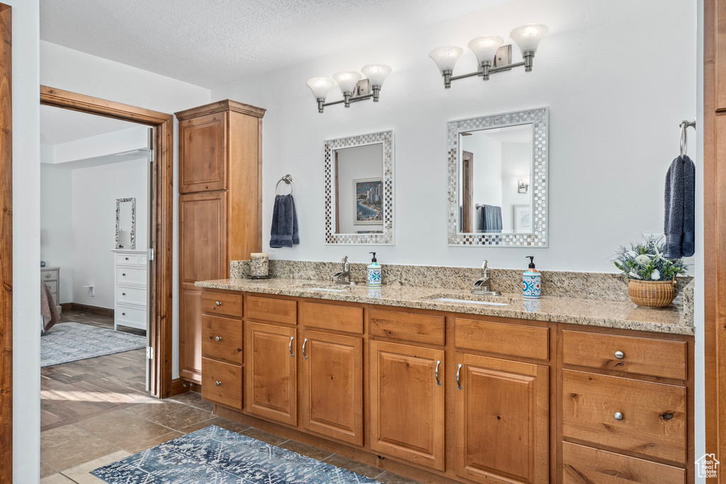 Ensuite bathroom with double vanity and a textured ceiling