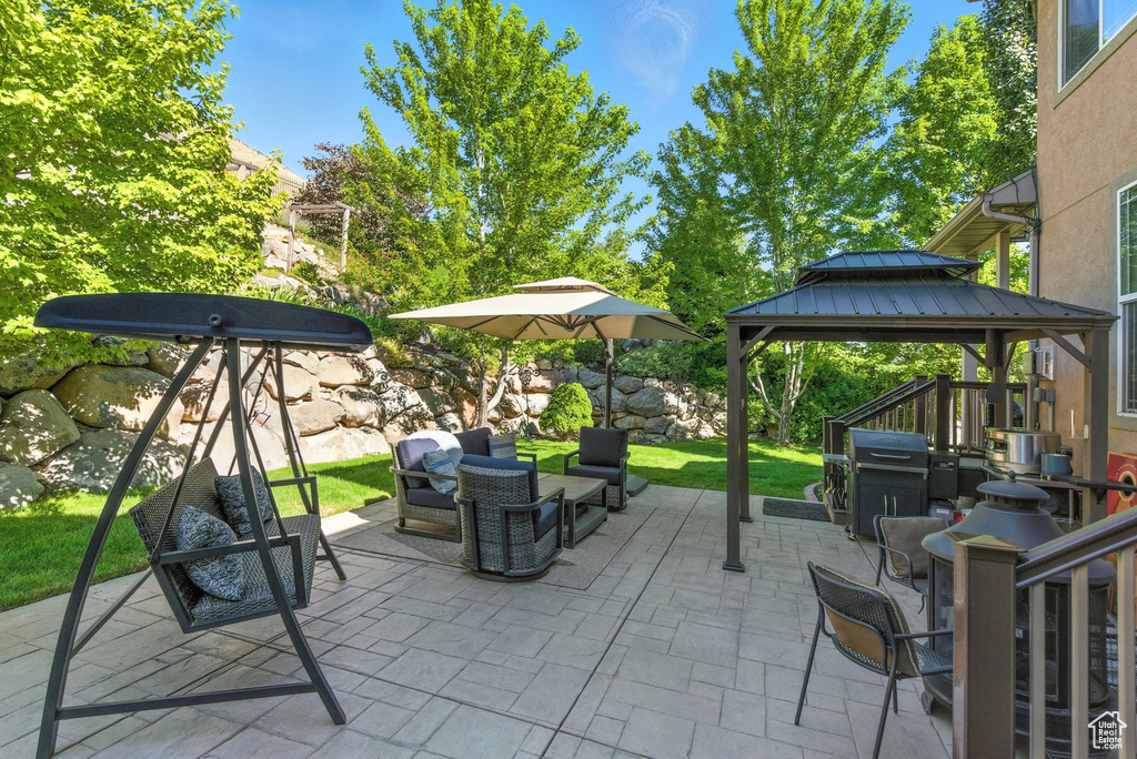 View of patio / terrace featuring a gazebo, an outdoor hangout area, and a grill