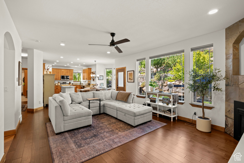 Living room with hardwood / wood-style flooring, ceiling fan, plenty of natural light, and recessed lighting